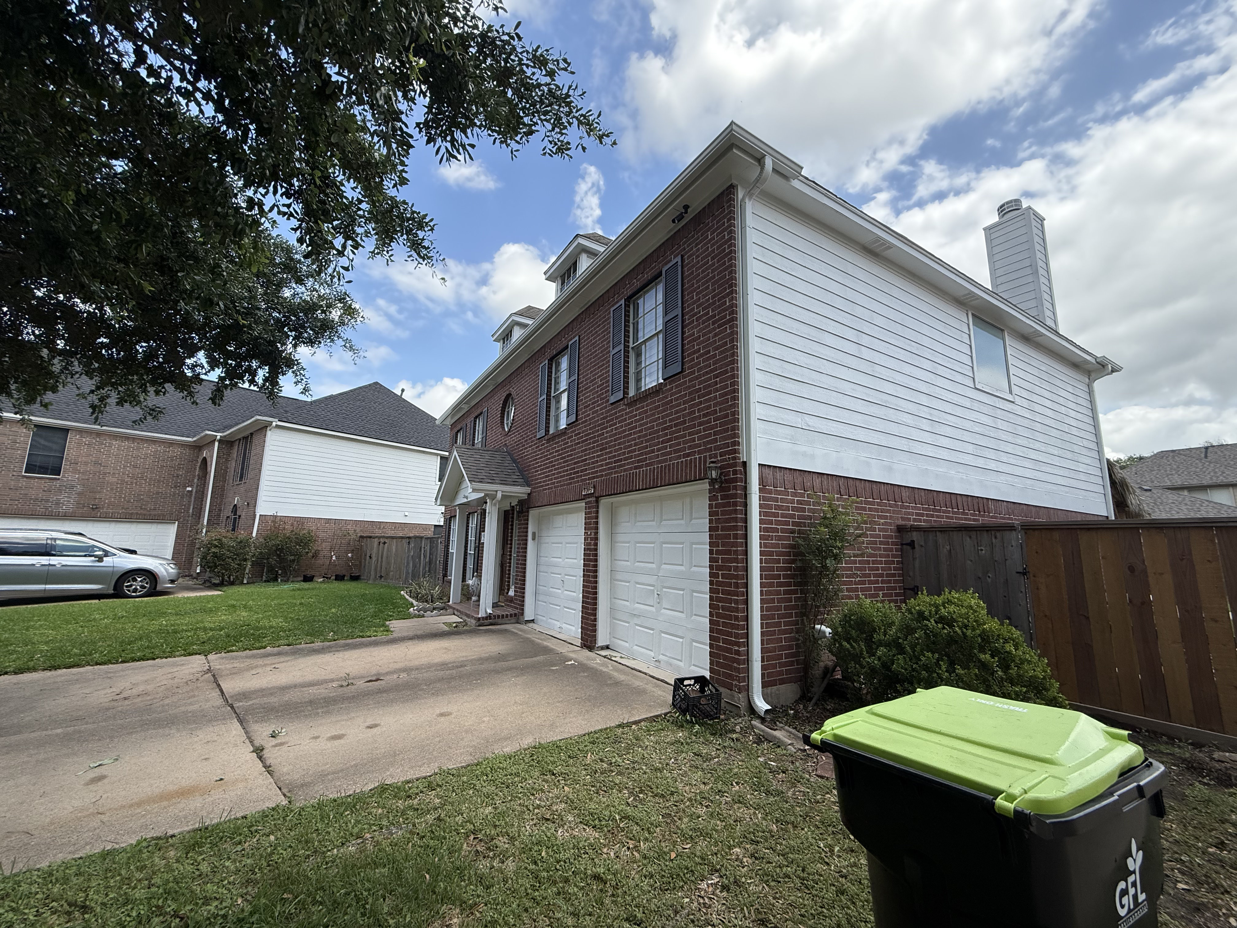 Brick and white siding combination on two-story home