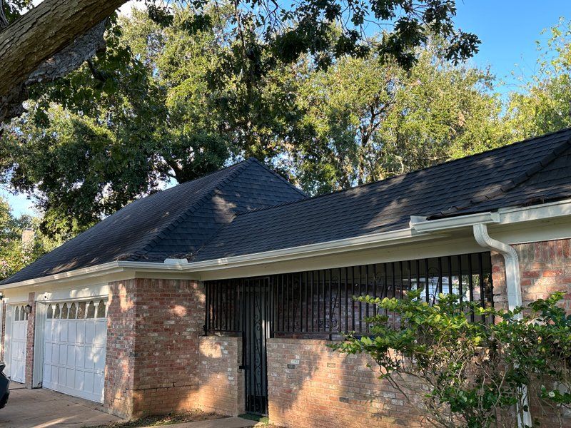 Seamless gutter line along a brick home roofline