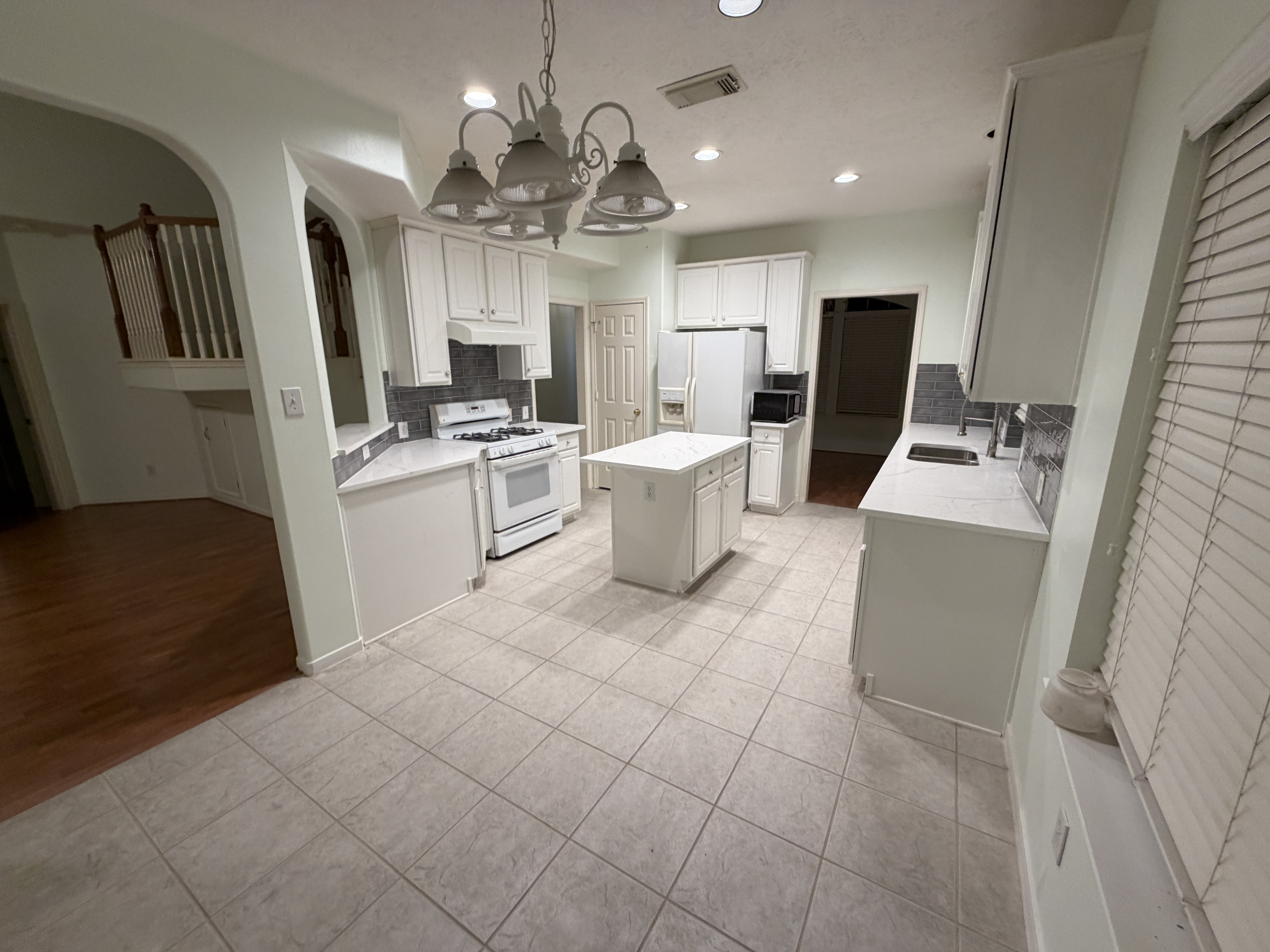 Full kitchen remodel with white cabinets and quartz countertops