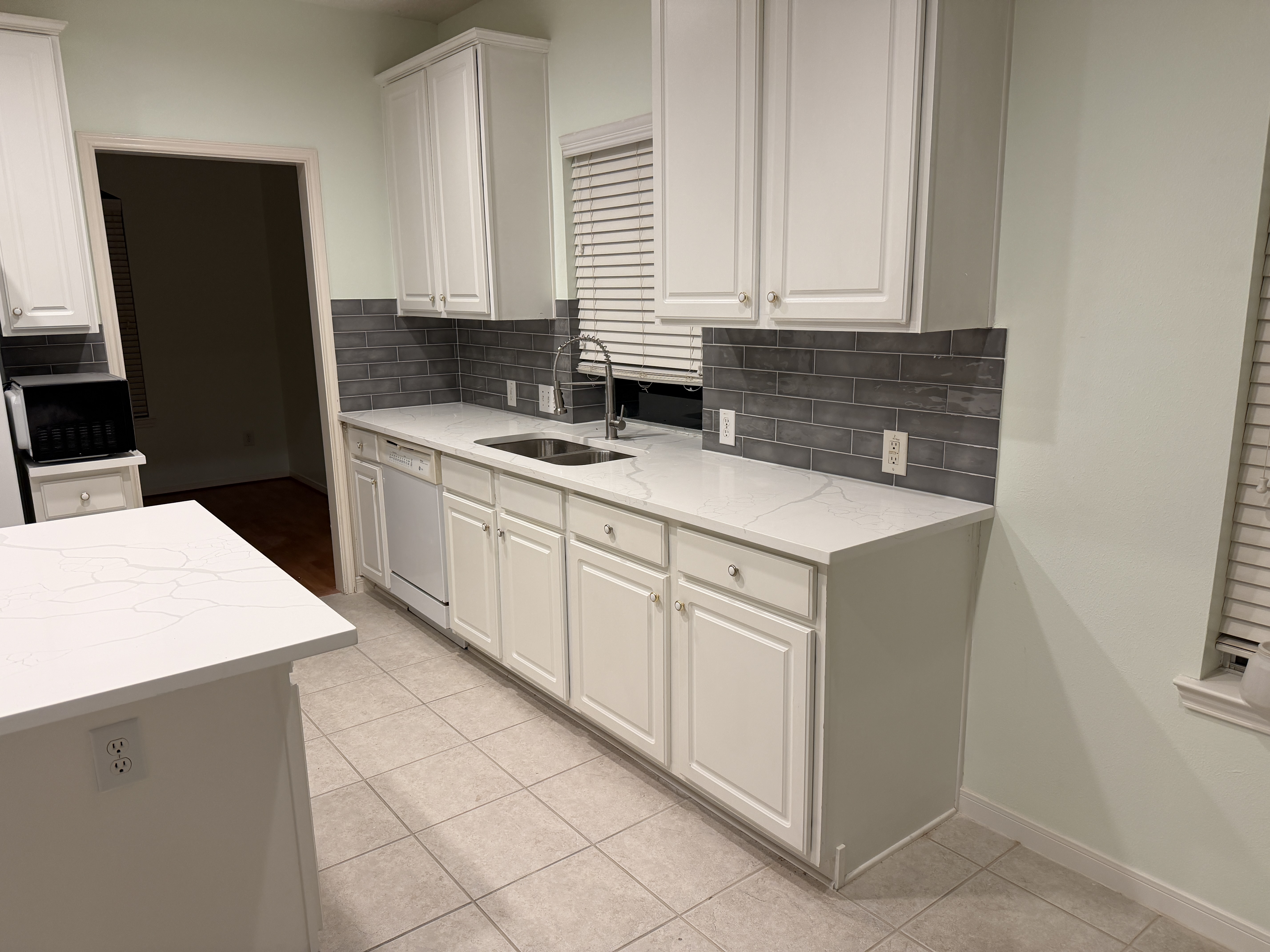 Kitchen remodel with quartz countertops and subway tile backsplash