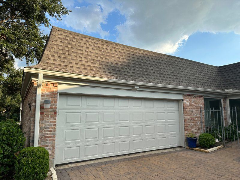 New color-matched seamless gutters above a garage