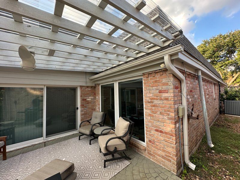 Covered patio and pergola exterior project with new gutters and downspouts