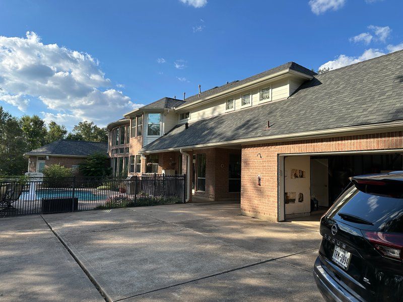 Seamless gutter installation on a large two-story home