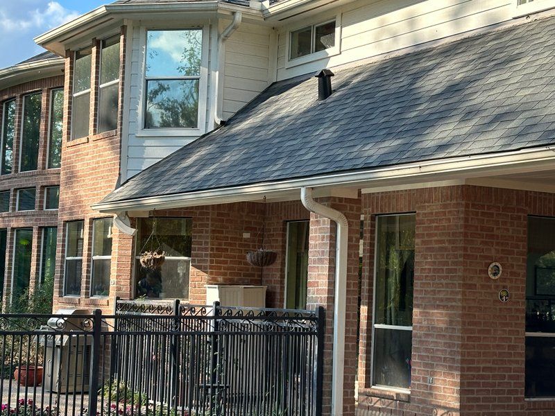 Front elevation of a brick home with new seamless gutters