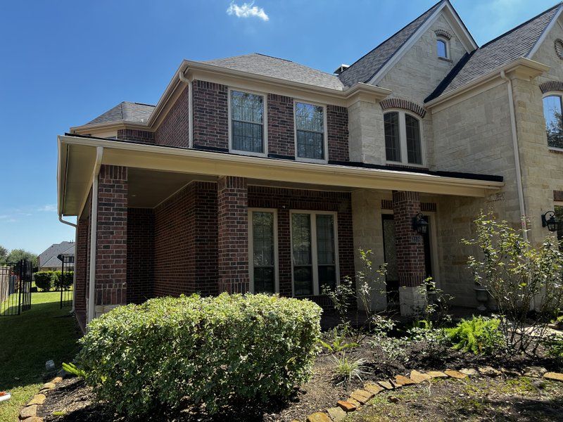 New seamless gutters on a two-story brick home