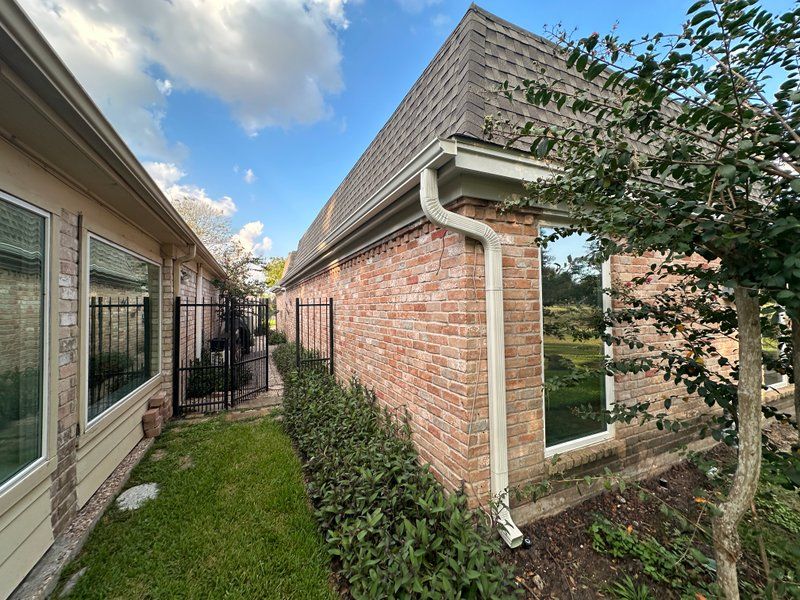Side gutter run with downspout on a brick home