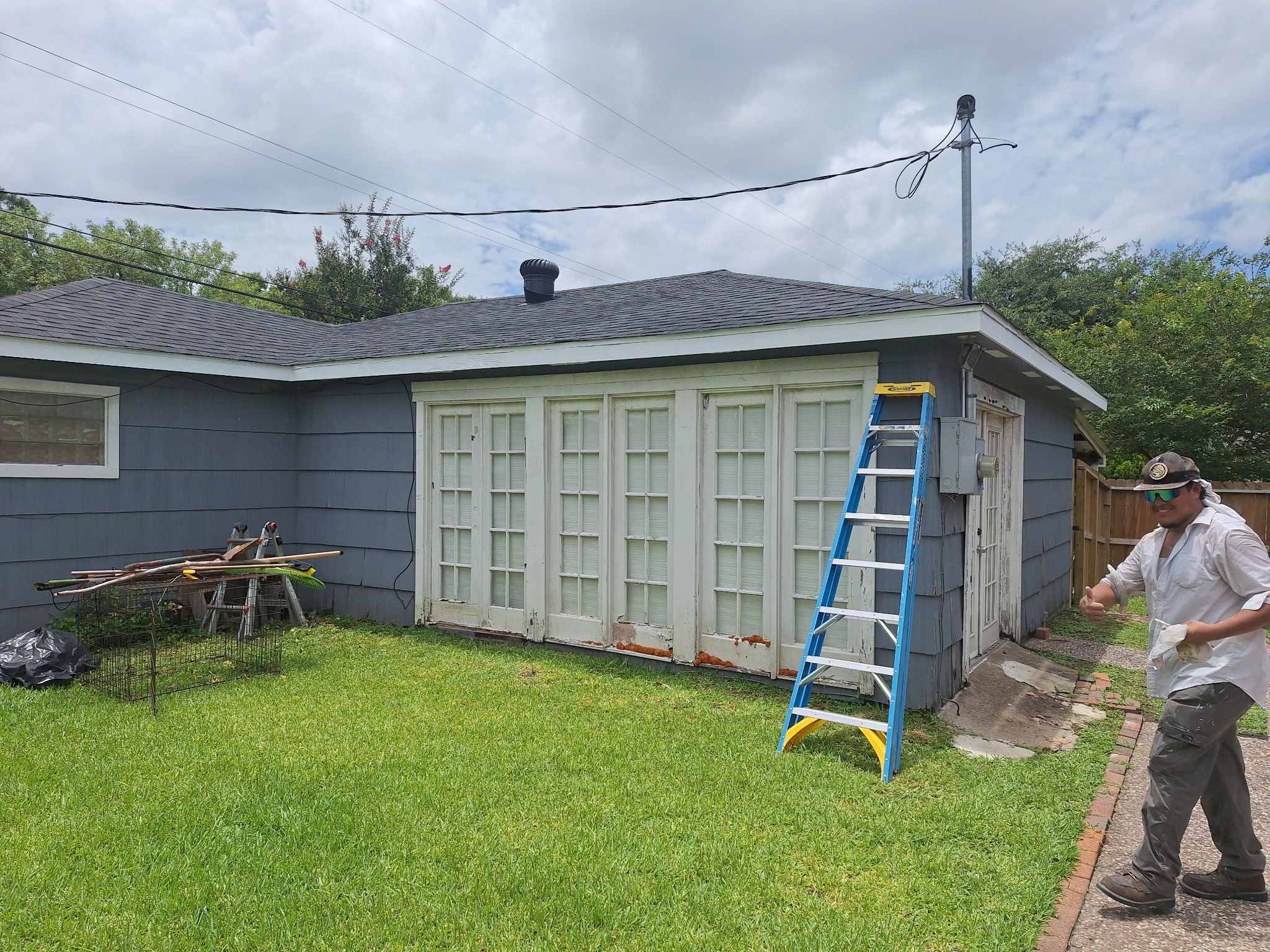 Siding installation in progress on blue home